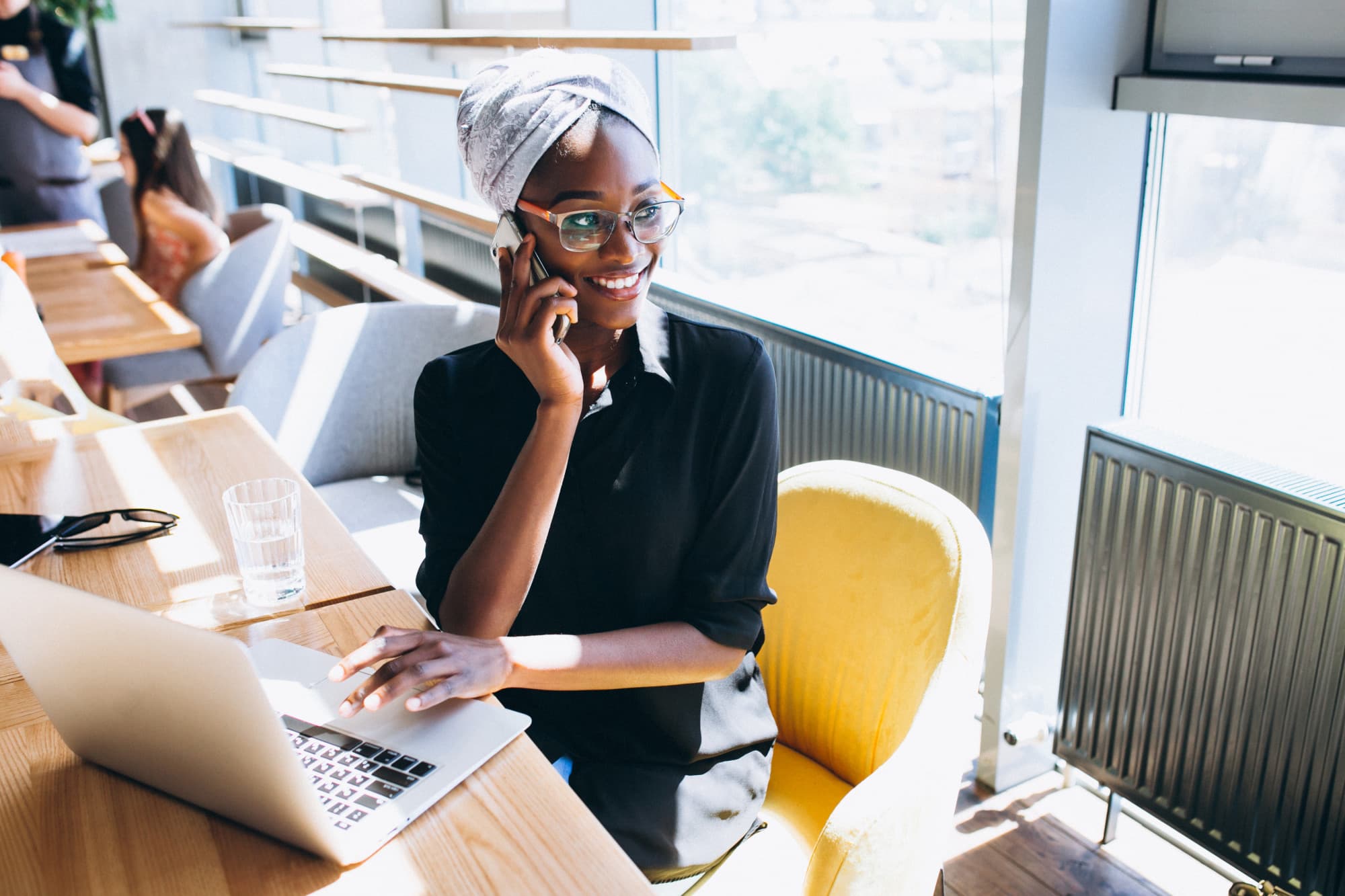 Nigerian brand marketer running a WhatsApp campaign from her laptop
